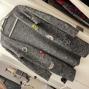 Long sweater with cool patches.